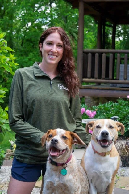 Female dog trainer with two dogs